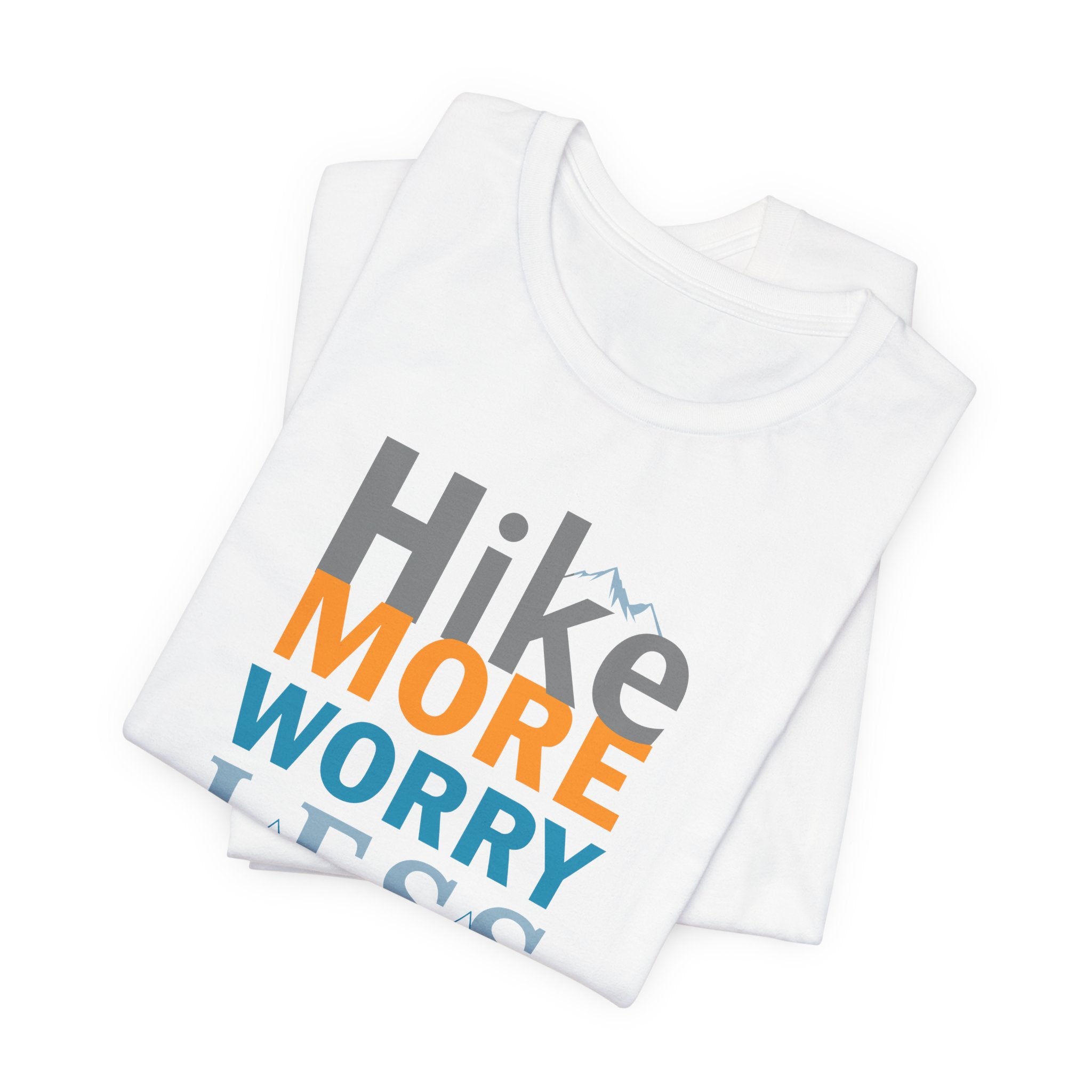 White crew neck t-shirt with the text 'Hike More Worry Less' printed in a gradient of orange, gray, and blue.