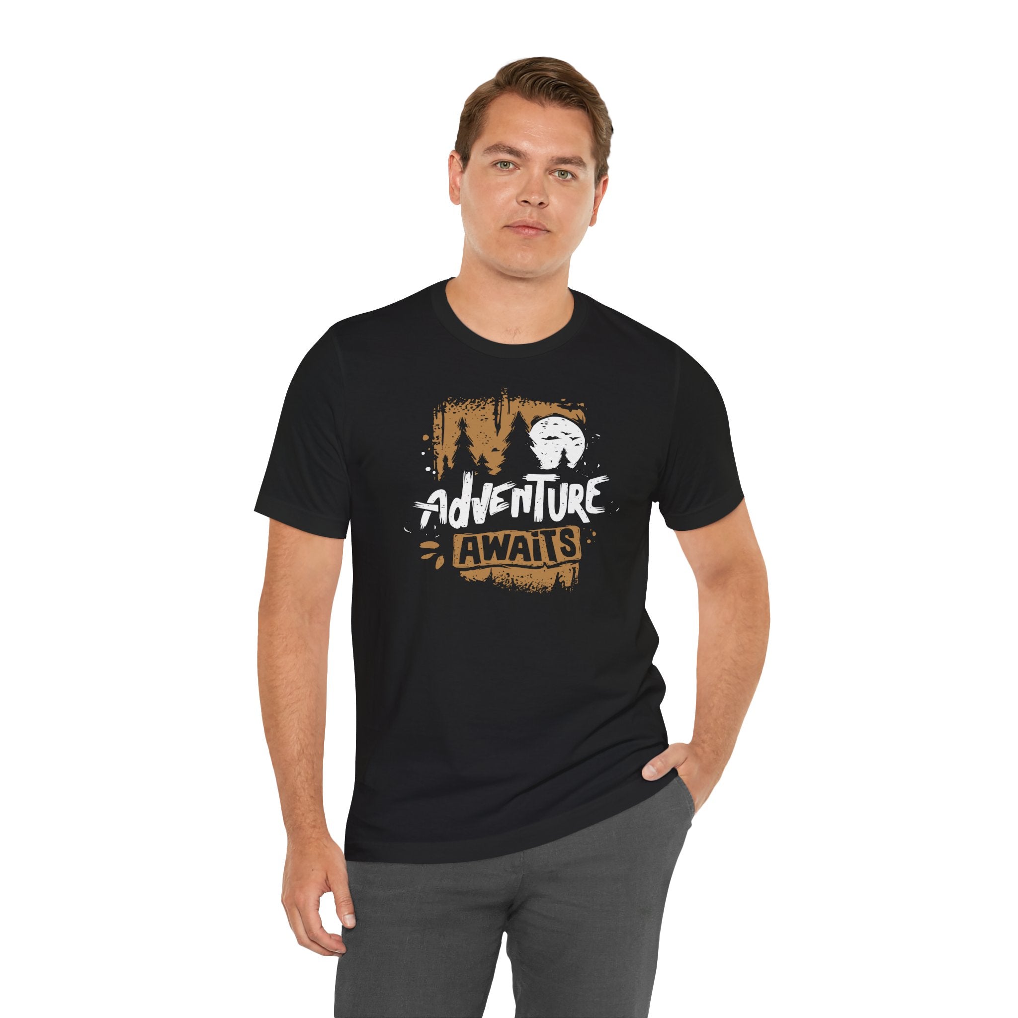 Man wearing a black t-shirt with 'Adventure Awaits' graphic design on a white background