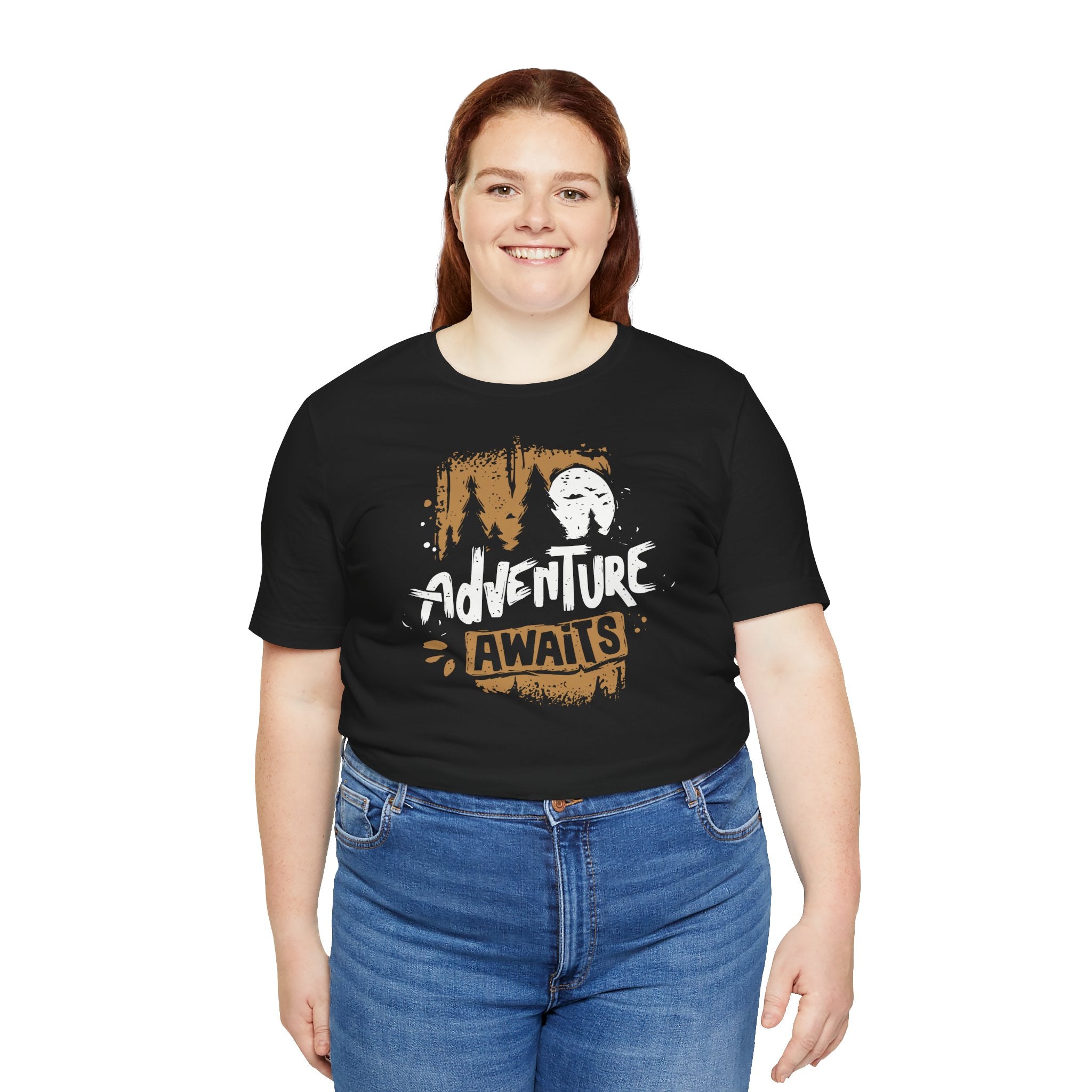 Person wearing a black t-shirt with 'Adventure Awaits' text and graphics on a white background