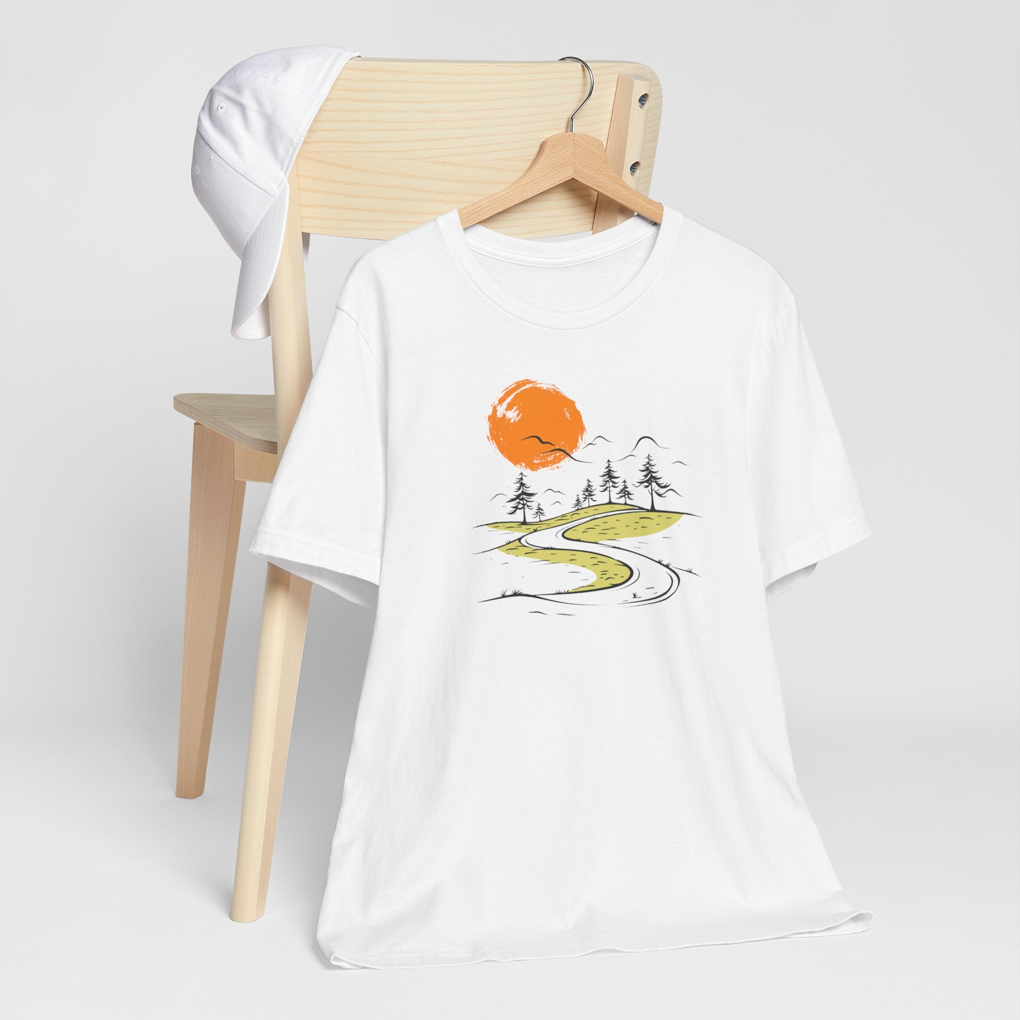 White t-shirt with minimalist nature road and orange sun graphic