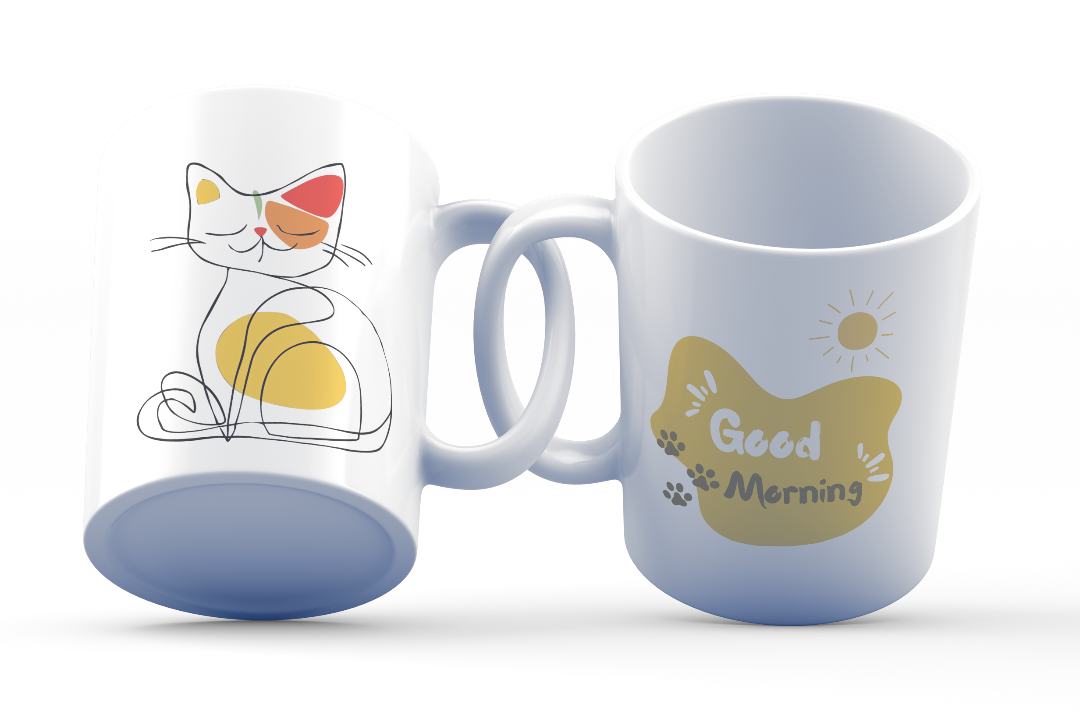 A white ceramic coffee cup with a colorful illustration of a cat and a 'Good Morning' message on the sides.
