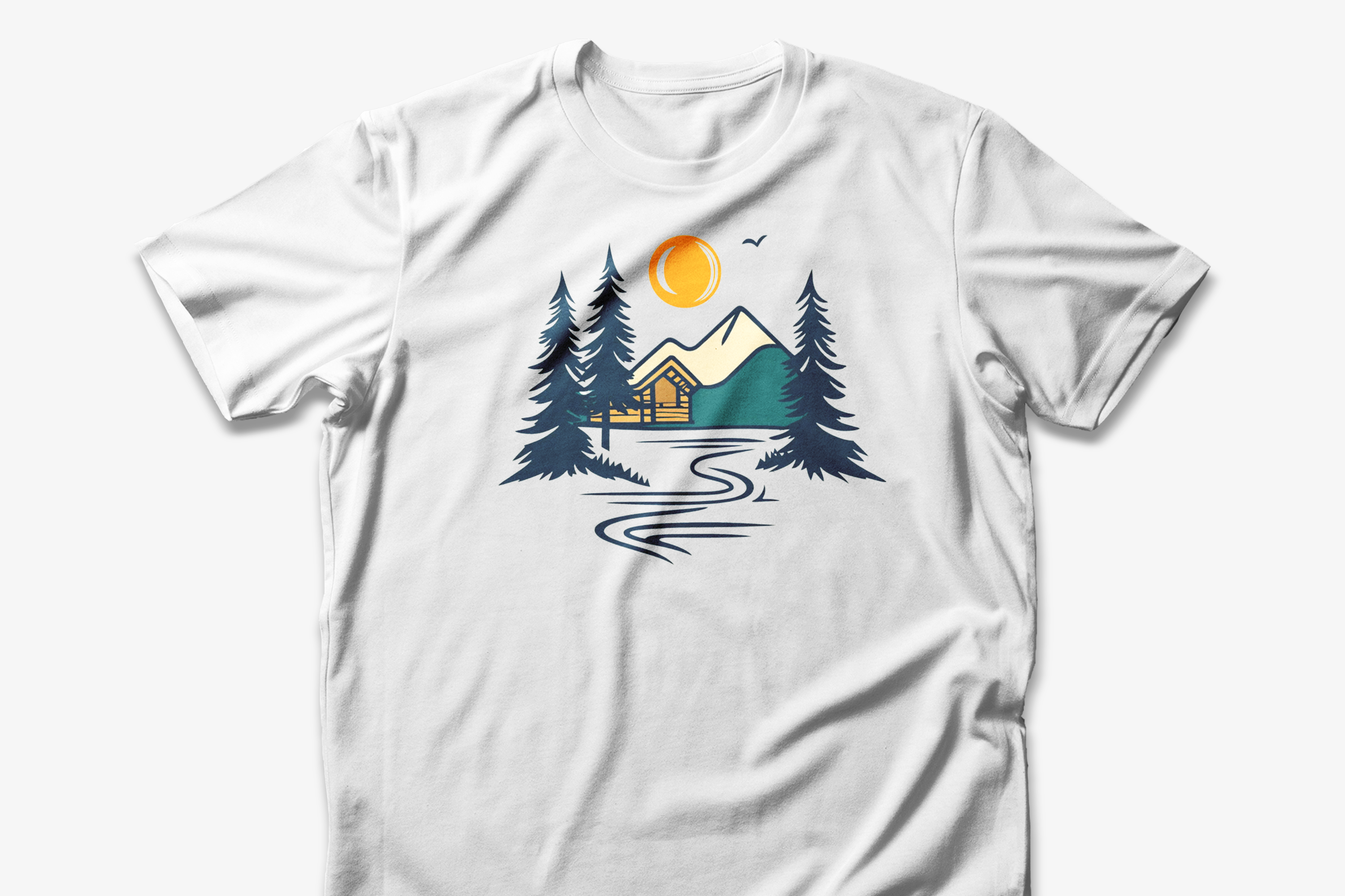 A white cotton t-shirt with a graphic design featuring a cabin, trees, and a mountain range with a warm orange sun.