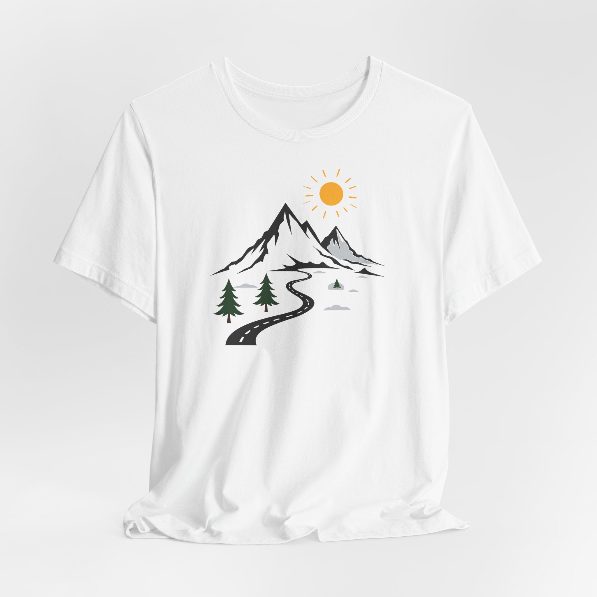 A white crew neck t-shirt with a graphic print of mountains, a winding road, and sun.