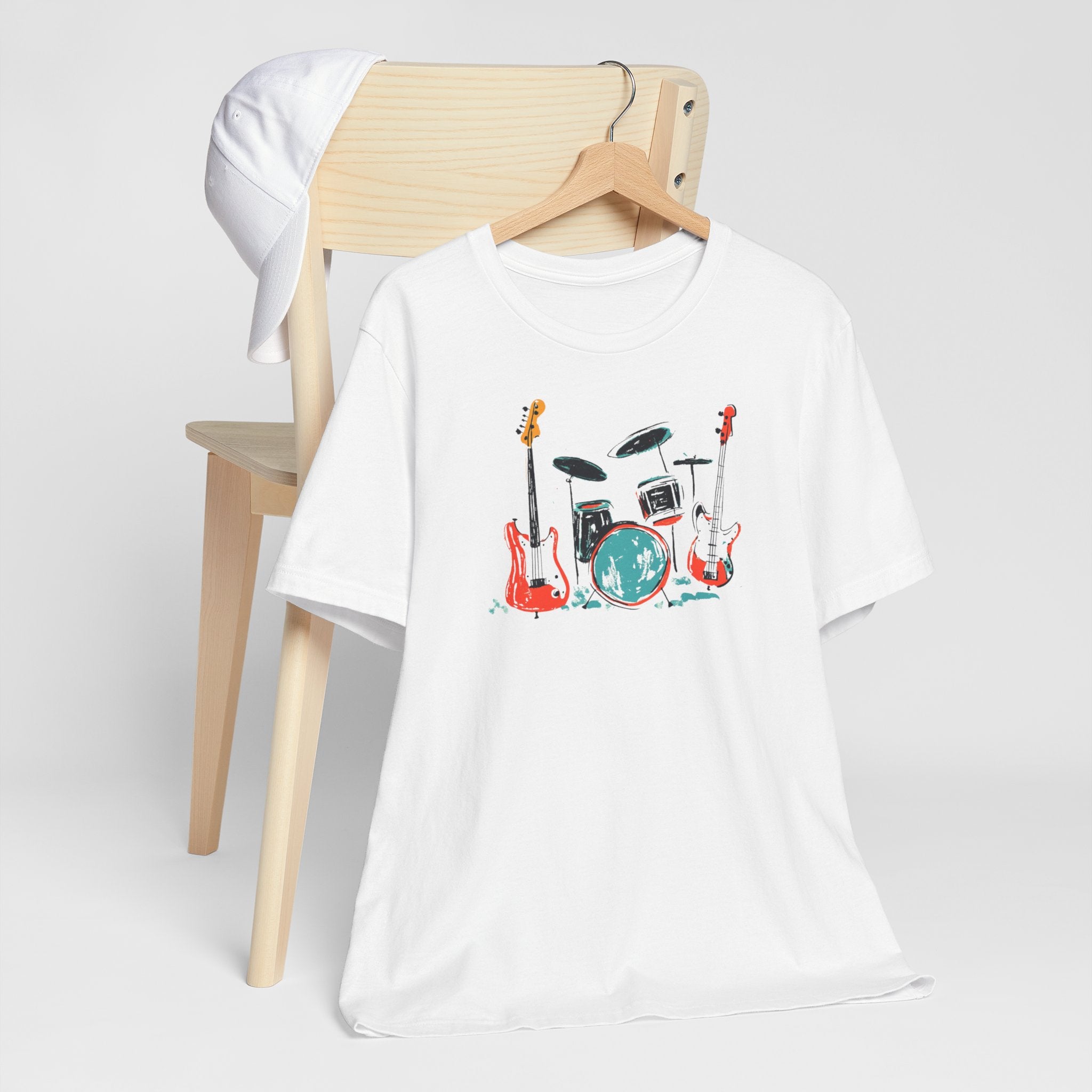 White t-shirt with rock band graphic featuring drum set and guitars