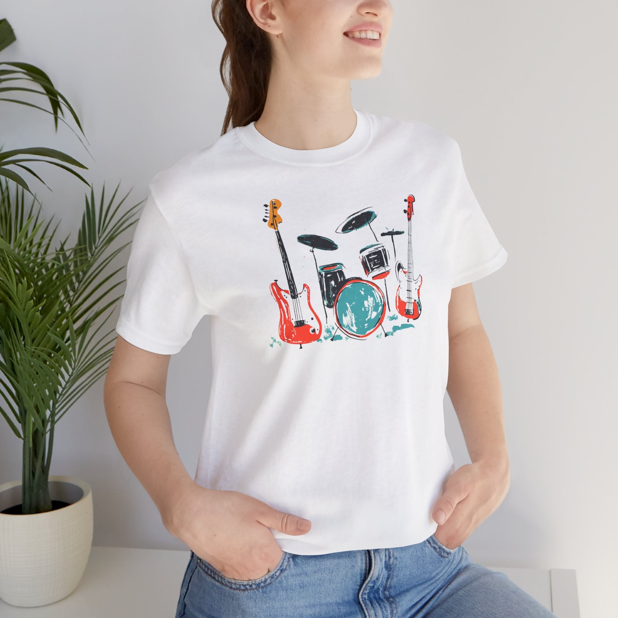 White t-shirt with rock band graphic featuring drum set and guitars
