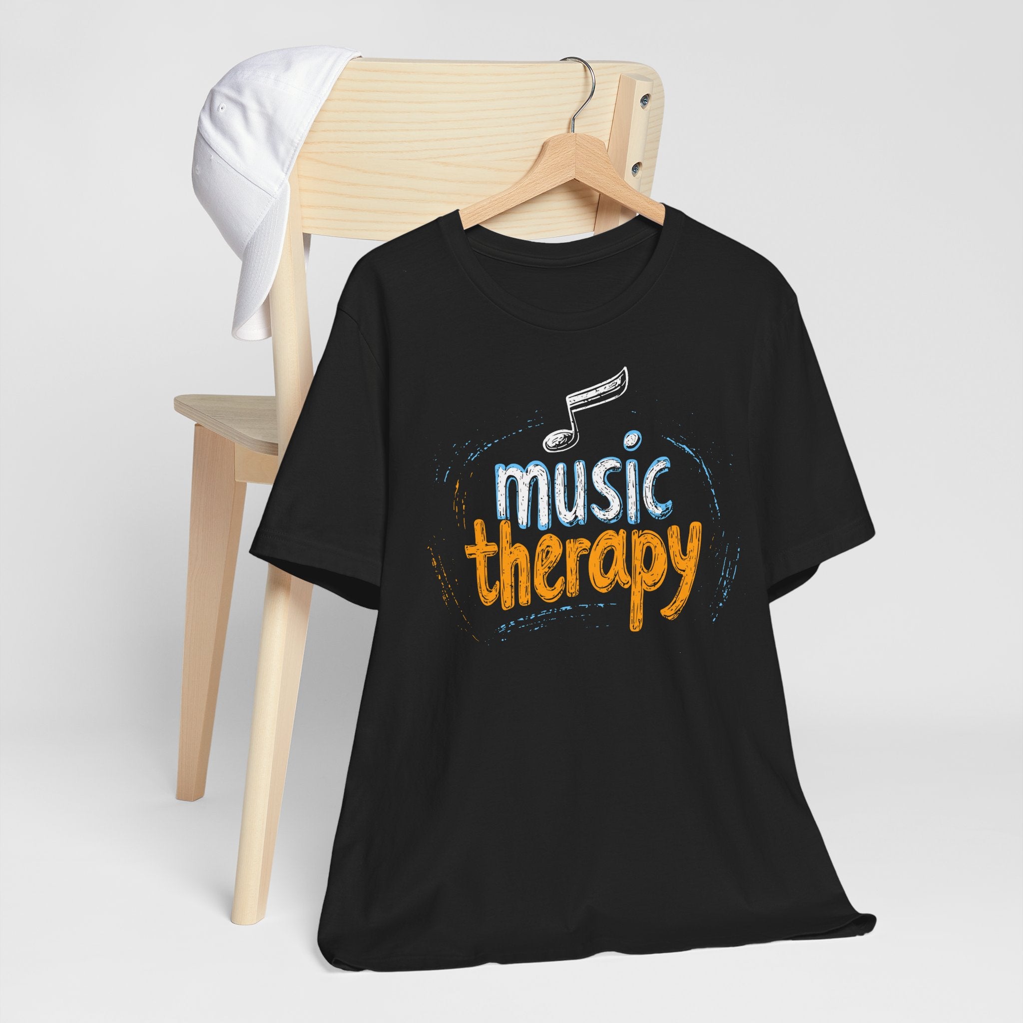 Black t-shirt with 'music therapy' text and musical note on a white background