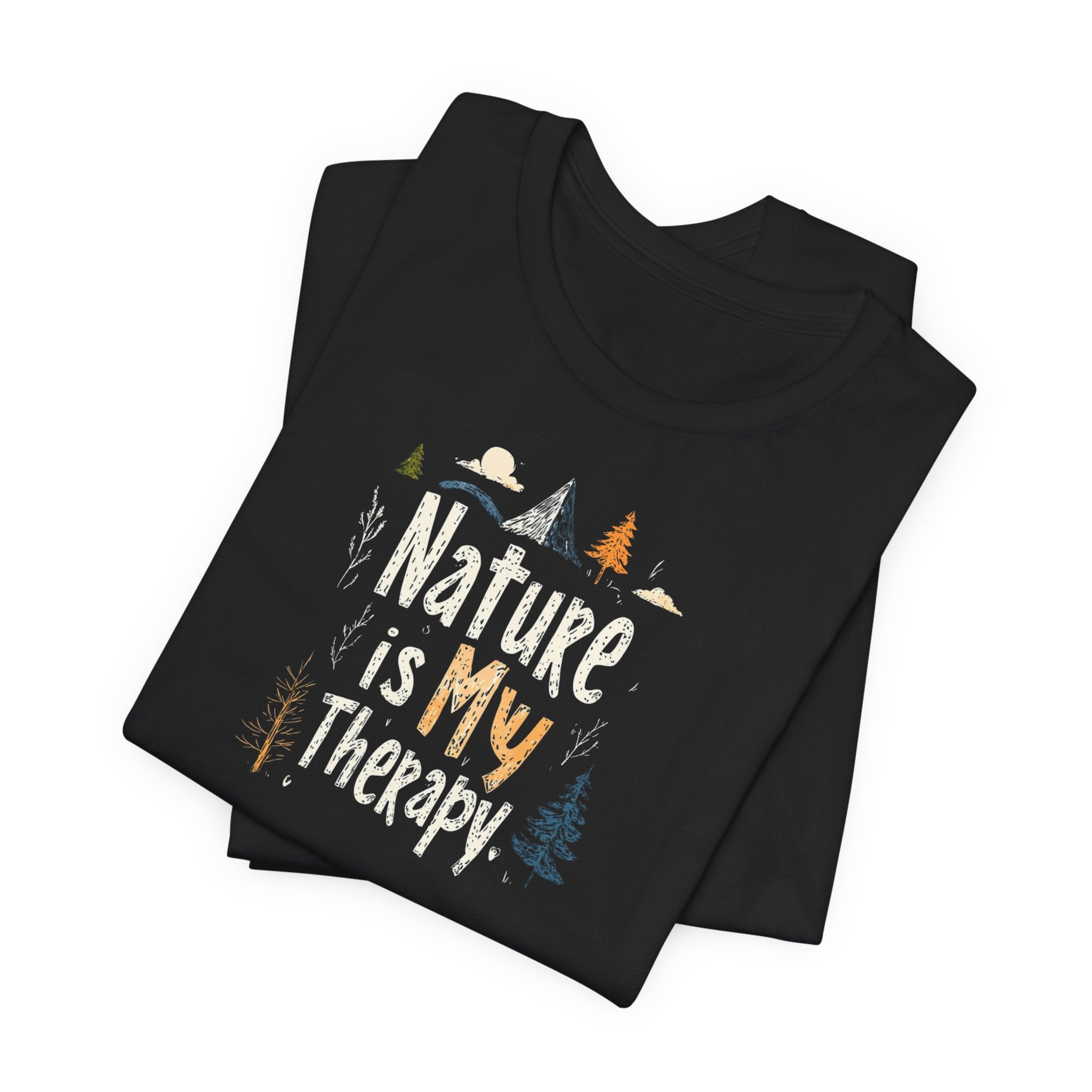 A black cotton t-shirt with a graphic design that includes mountains, trees, and the text 'Nature Is My Therapy'.