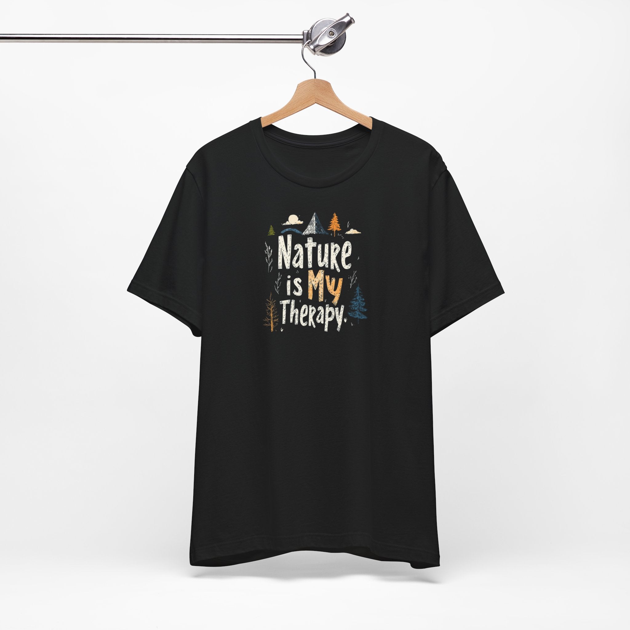 A black cotton t-shirt with a graphic design that includes mountains, trees, and the text 'Nature Is My Therapy'.