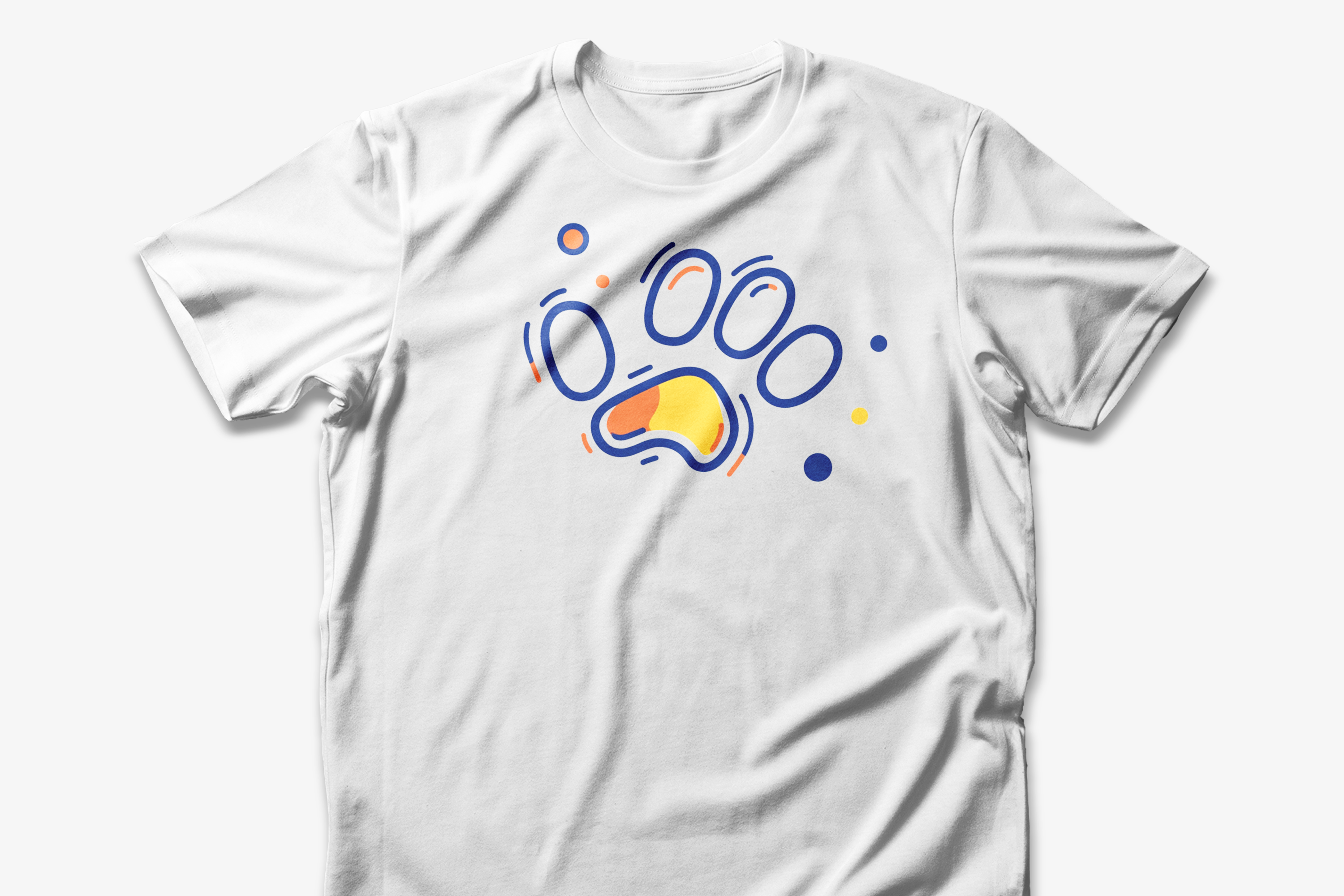 A white cotton t-shirt featuring a vibrant geometric paw print design in orange and navy tones, with abstract shapes.