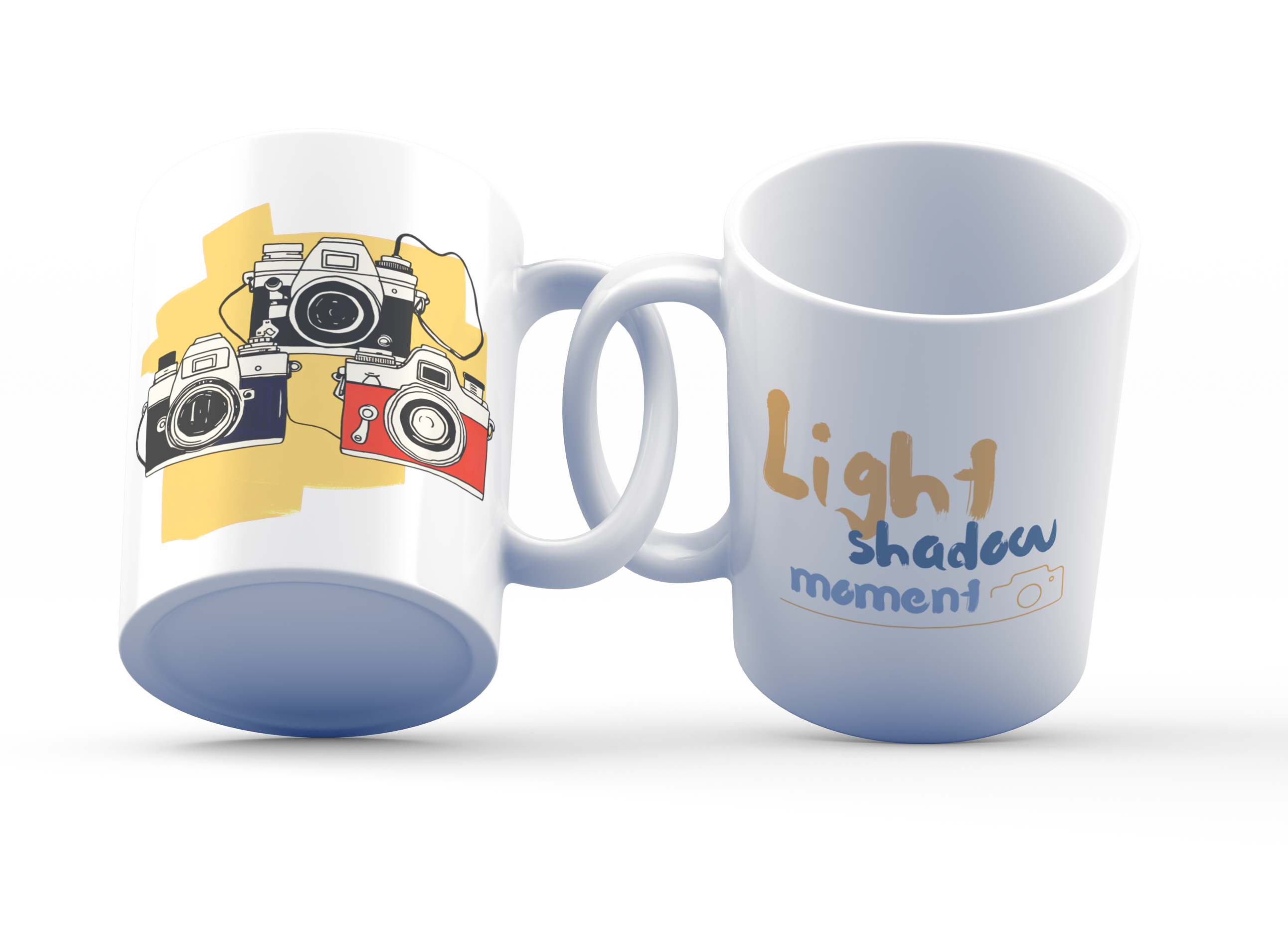 Two ceramic mugs, one with a colorful retro camera collage design and the text 'Light, Shadow, Moment!' The other mug is plain white with no design.