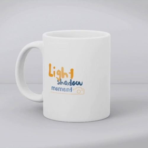 Colorful artistic camera mug with 'Light shadow moment' quote, a vibrant 11oz coffee cup gift for photographers and artists.