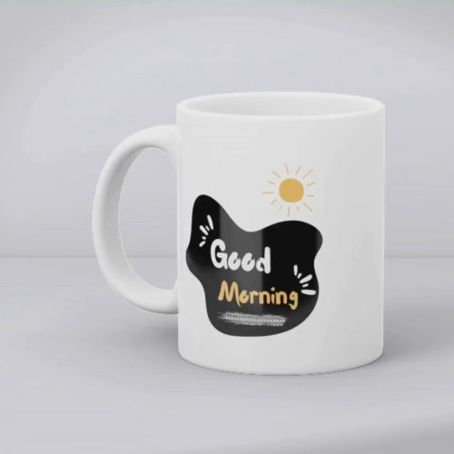 Two white ceramic mugs, one with a minimalist black bicycle design and the other featuring a 'Good Morning' message with a yellow sun accent, both with bold black and yellow prints.