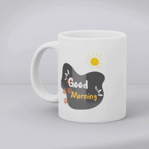 Two ceramic mugs, one with a paw print design and the other with a 'Good Morning' message, both with a white background.