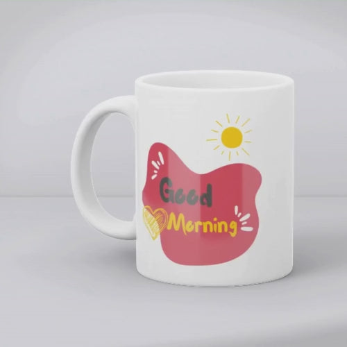 A ceramic coffee mug with a double-sided design featuring a heart pattern on one side and a 'Good Morning' message with a heart motif on the other, presented in a white background.