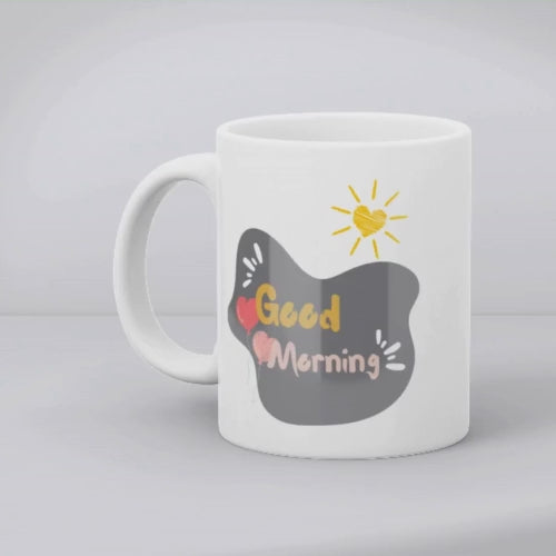 Two ceramic coffee mugs with heart and balloon patterns, one with a 'Good Morning' message and the other with a 'Good Night' message.