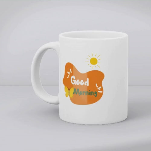 Two ceramic mugs with nature-inspired designs. One mug displays a colorful forest scene with trees and the sun, while the other mug has a 'Good Morning' message with a sun and coffee-related graphics.
