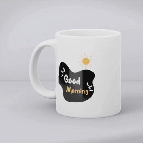A set of two ceramic mugs, one with various playful cartoon faces and the other with a 'Good Morning' message accompanied by a sun illustration.