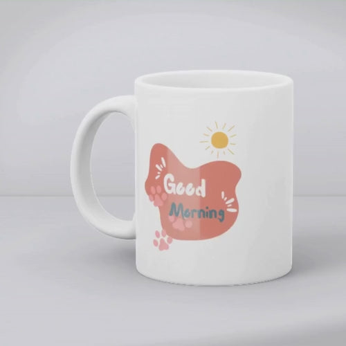 A set of two ceramic mugs, one with a splash of colorful paw prints and the other with a 'Good Morning' message in soft pink, both with animal-themed designs.