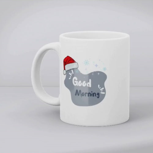 Two ceramic mugs, one with a Christmas tree design and the other with a Santa hat and snowflakes, both with 'Good Morning' text.