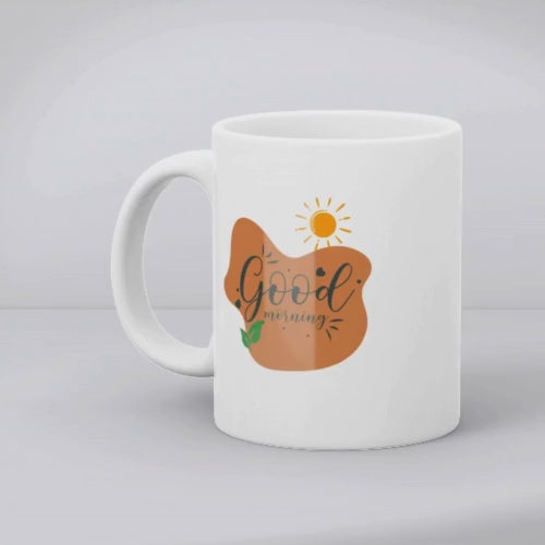 A set of two ceramic mugs, one with a minimalist sunrise design and the other with 'Good Morning' text in a natural tone, both featuring nature-inspired illustrations.