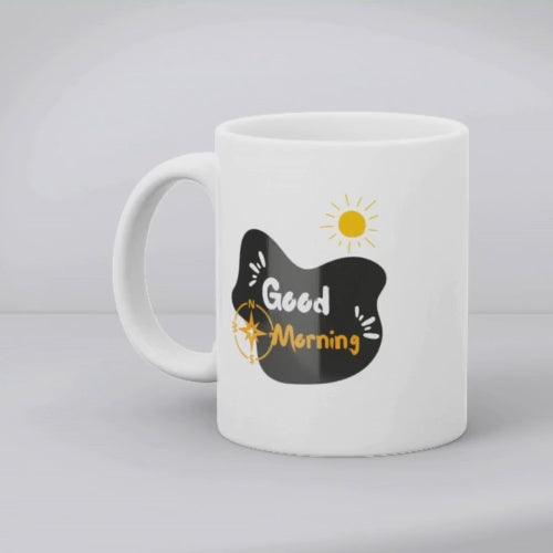 Two ceramic mugs side by side, one with a mountain design and the other with a sunrise and sunburst design, both featuring text 'Good Morning'.