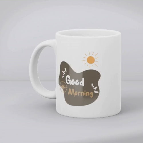 Two ceramic mugs, one with a mountain and sun design and the other with a 'Good Morning' message, both in minimalist style.