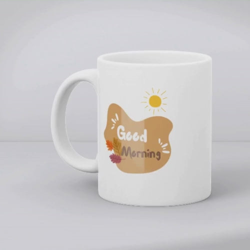 A set of two ceramic mugs, one with a floral design of golden roses and autumn leaves, and the other with a sun and leaves pattern, both with 'Good Morning' and 'Good Afternoon' text respectively.