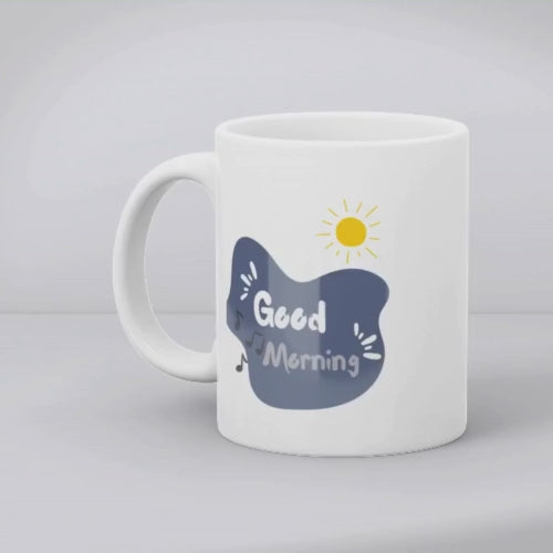 Two ceramic mugs side by side; one with a sketch of a drum kit primarily in black, white, and red, and the other with a 'Good Morning' message in a blue cloud, featuring a sun icon and musical notes.