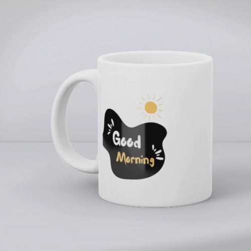 Two ceramic mugs, one with a minimalist smiley face design and the other with 'Good Morning' text and a sun graphic, both in black and yellow colors on a white background.