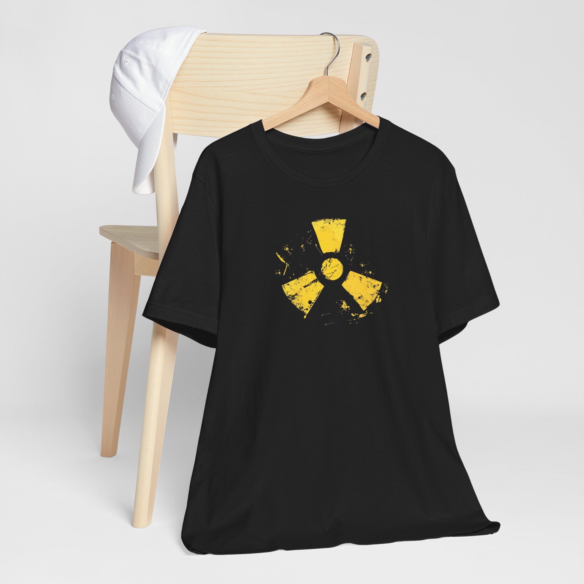 A black cotton tee with a grunge yellow hazard design of a radiation symbol on the front.