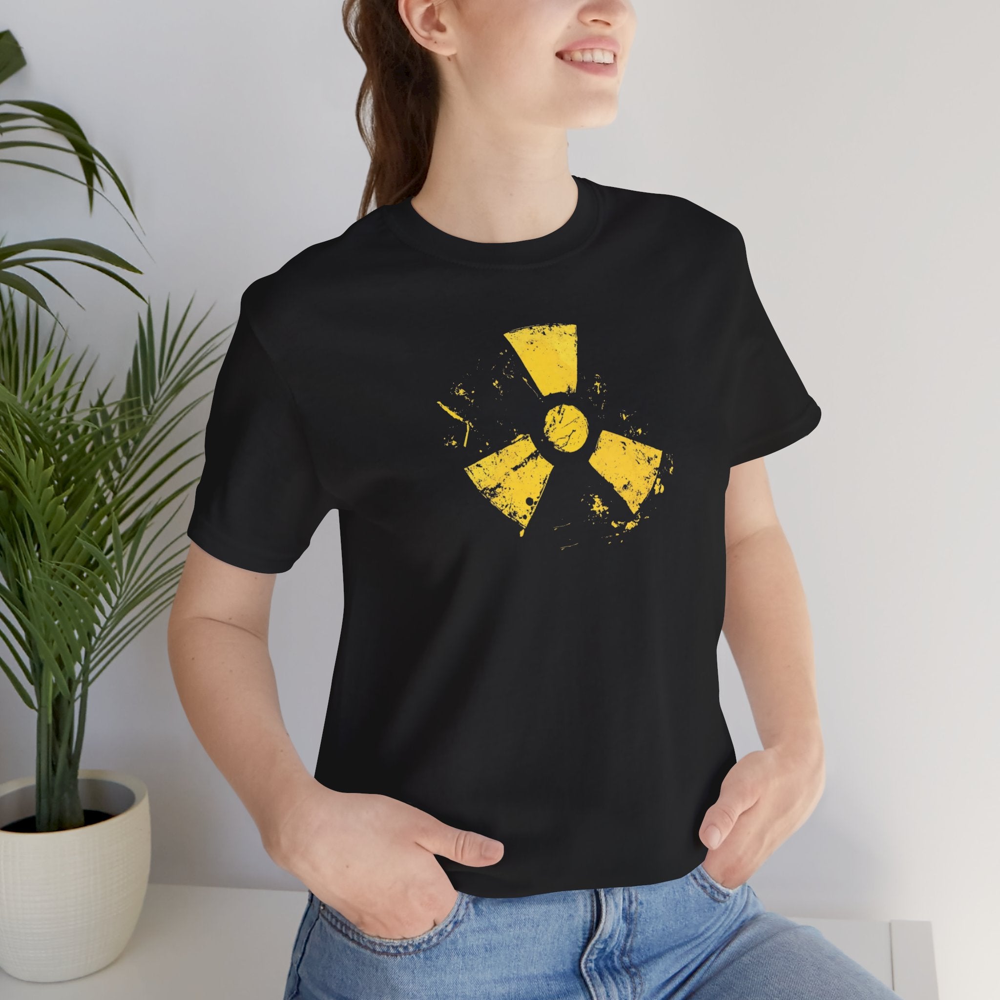 A black cotton tee with a grunge yellow hazard design of a radiation symbol on the front.
