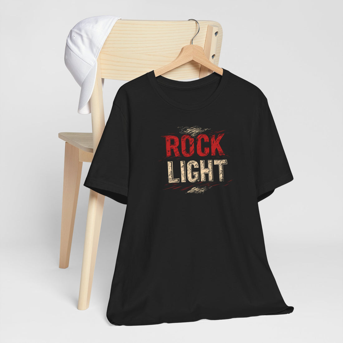 Closeup of distressed red and gold Rock Light print on black cotton tee
