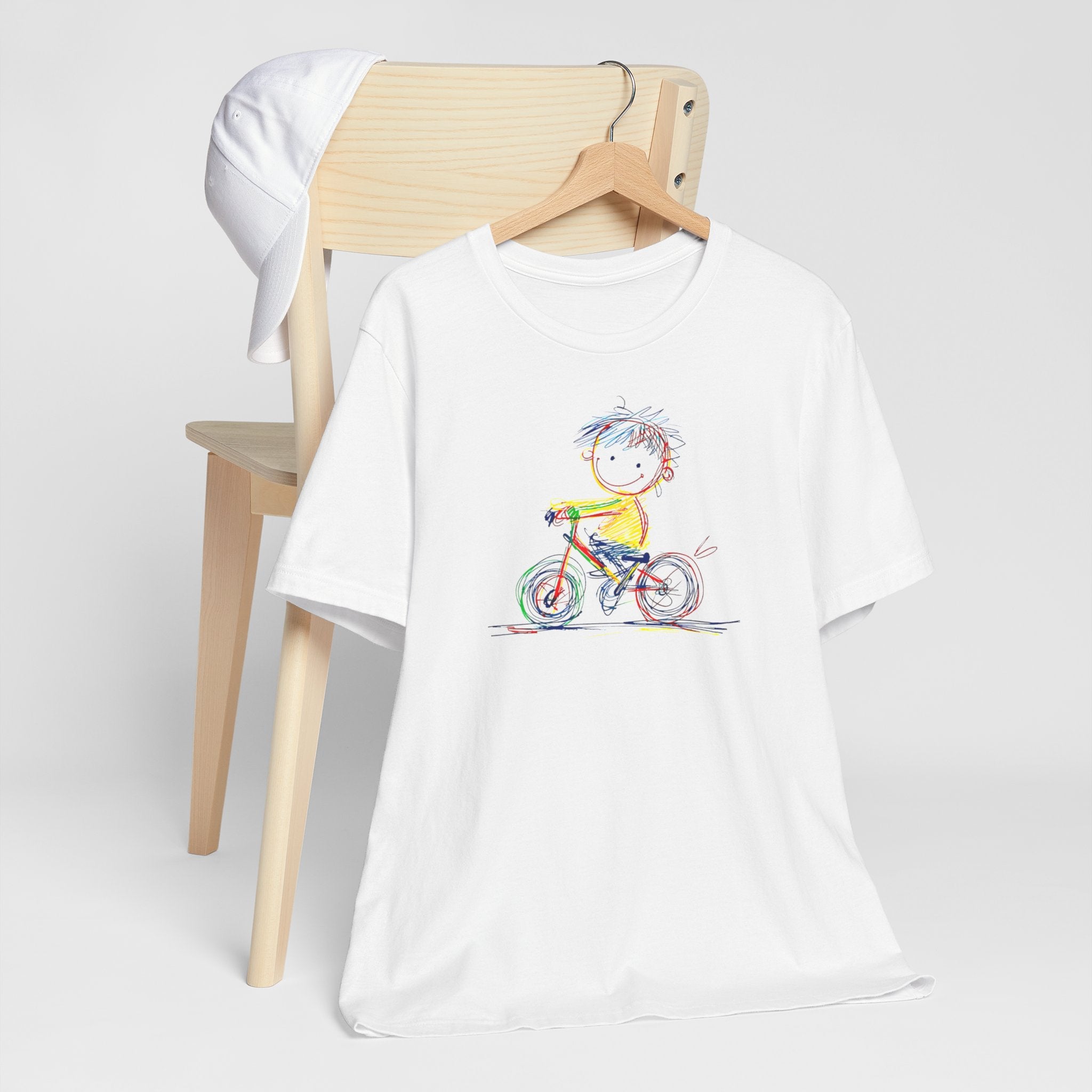 White t-shirt with colourful sketch of child on bicycle