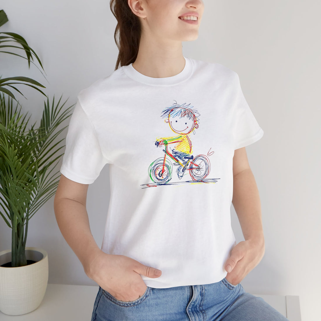 White t-shirt with colourful sketch of child on bicycle