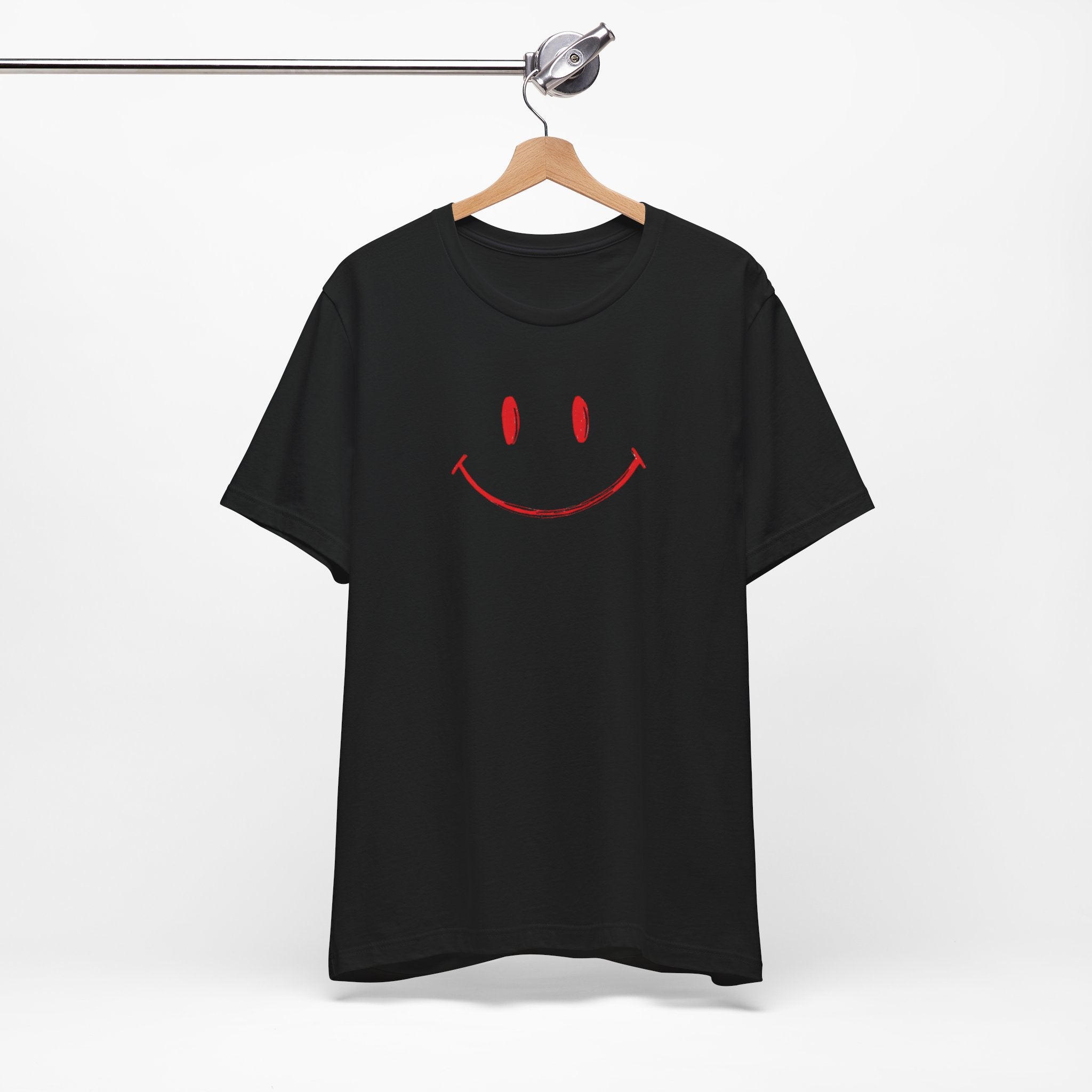 A black crew neck t-shirt with a minimalist hand-drawn red smiley face design on the front.