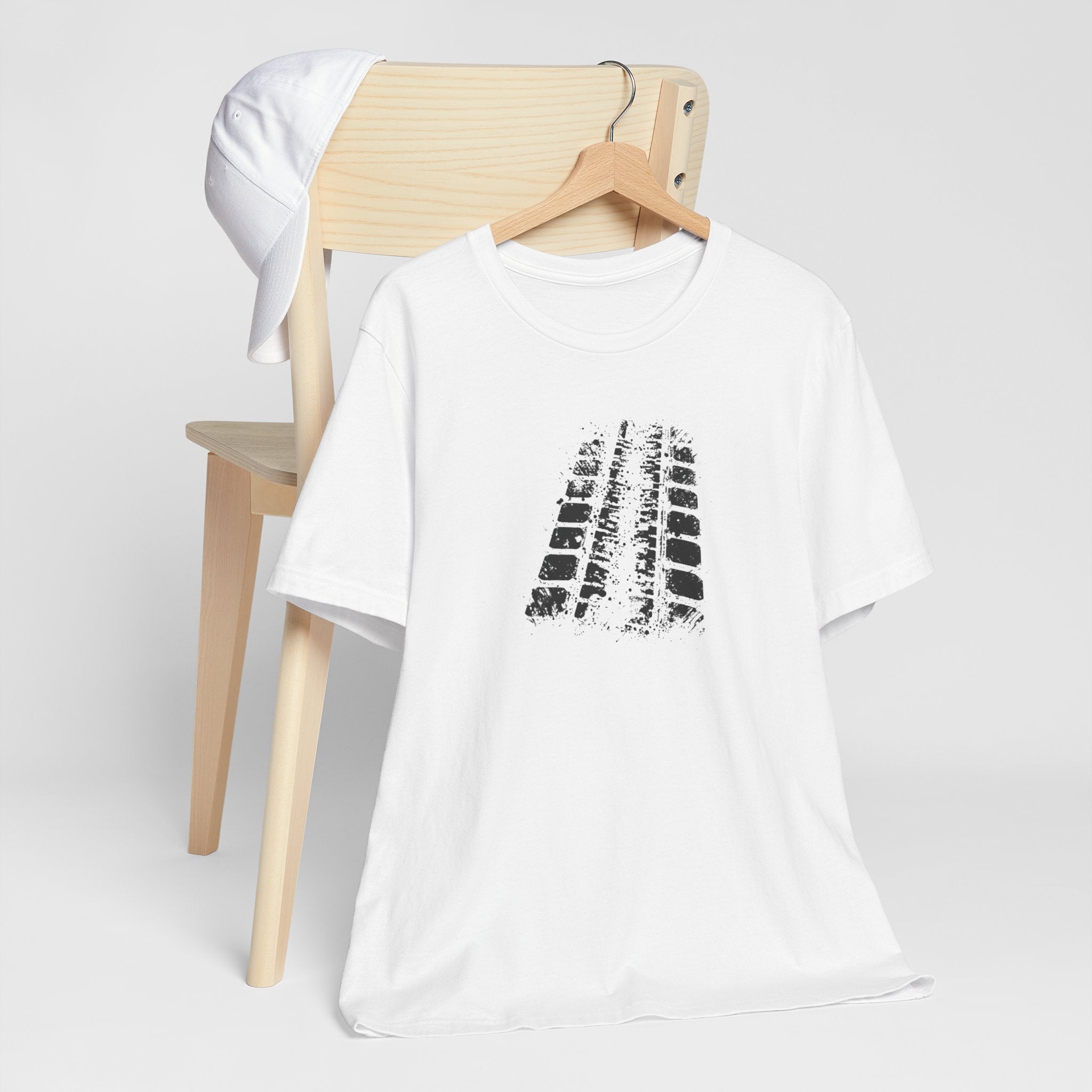 A white crew neck t-shirt with a bold black tire mark design on the front.