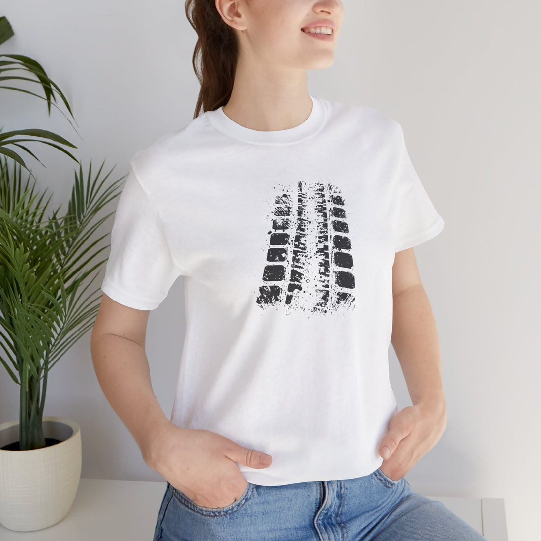 A white crew neck t-shirt with a bold black tire mark design on the front.