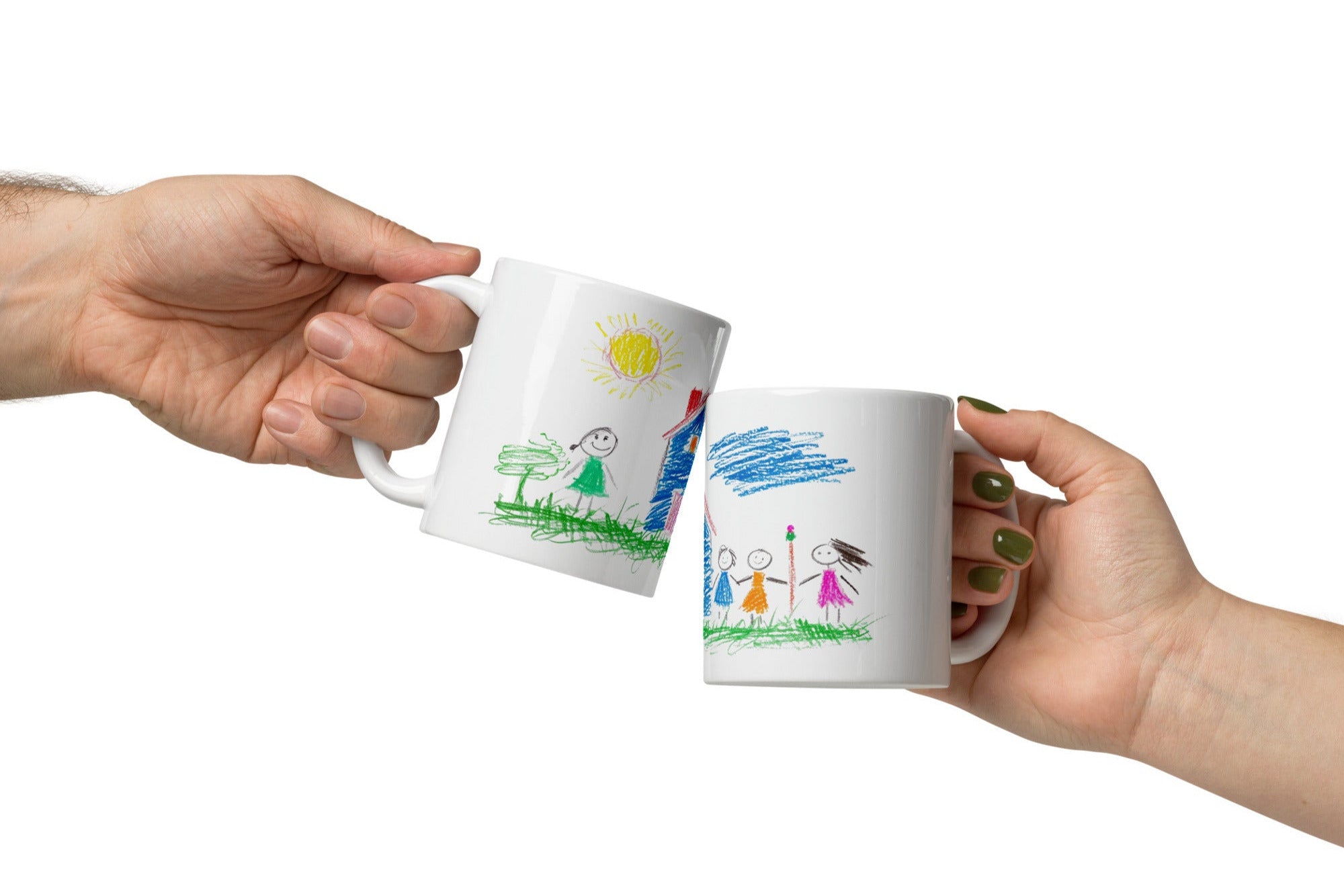 Two white ceramic mugs with colorful childlike drawings. One mug displays a house, sun, and a smiling family.