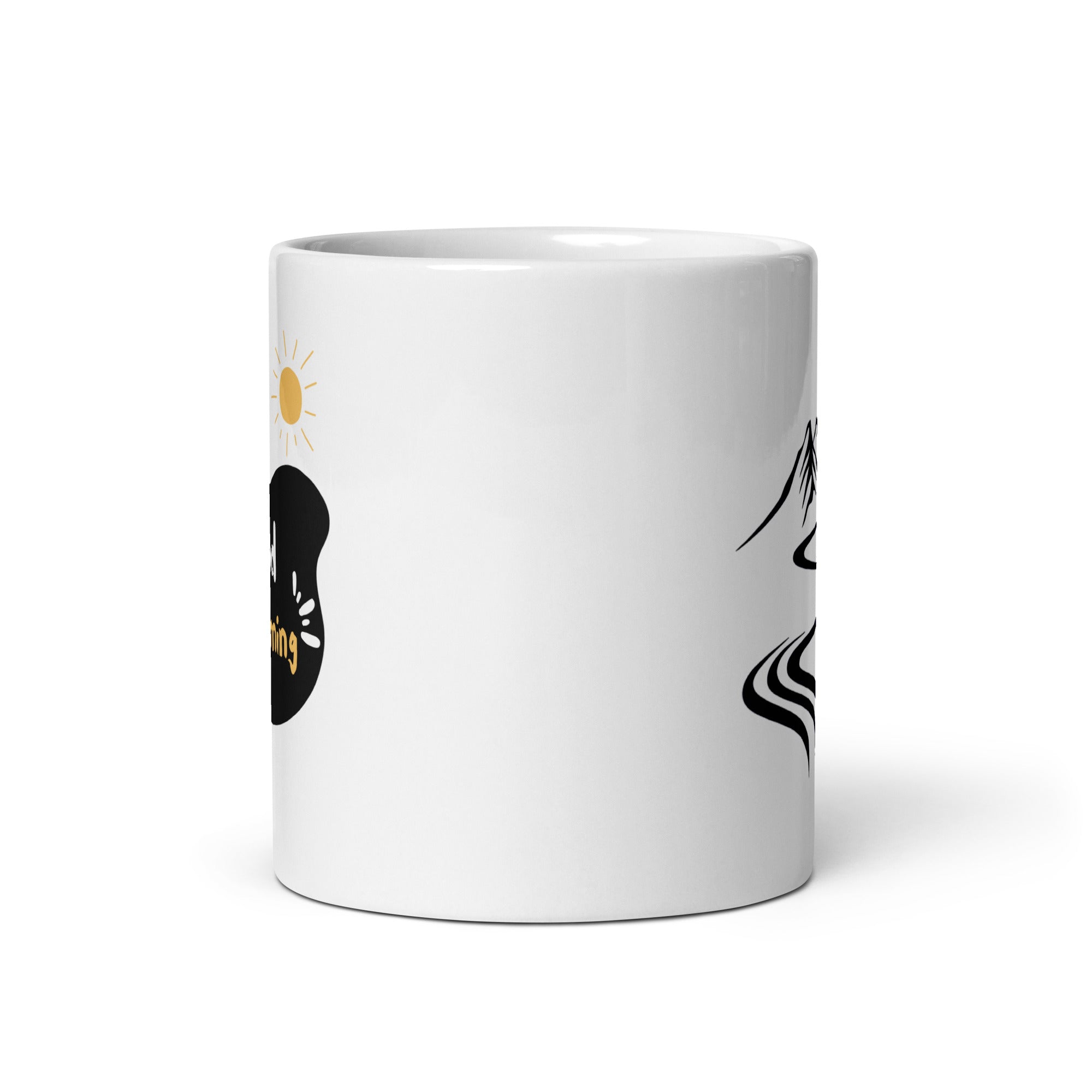 A glossy white ceramic mug with a mountain path design and a text 'GOOD MORNING' on the other side, placed against a plain background.