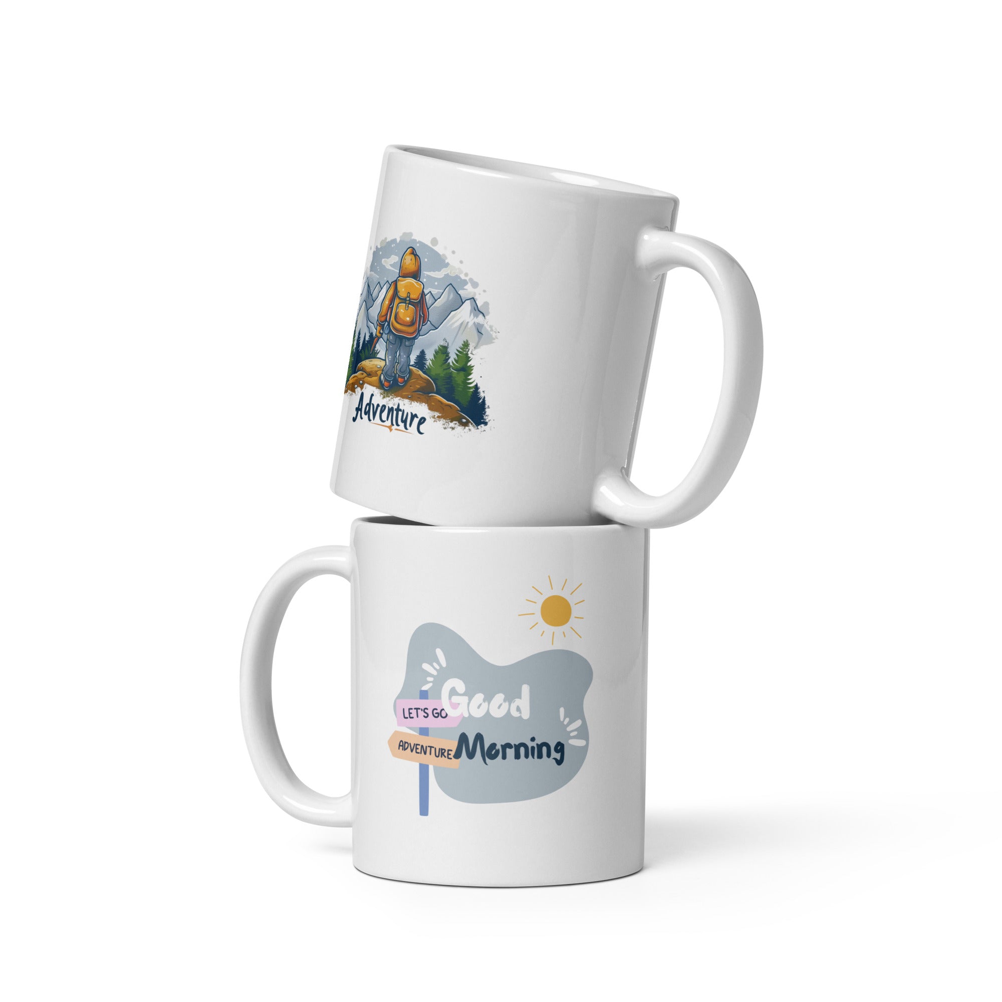 A set of two ceramic mugs, one with an adventure theme featuring a hiker on a mountain, and the other with a 'Good Morning' message, both with a snowy mountain backdrop.