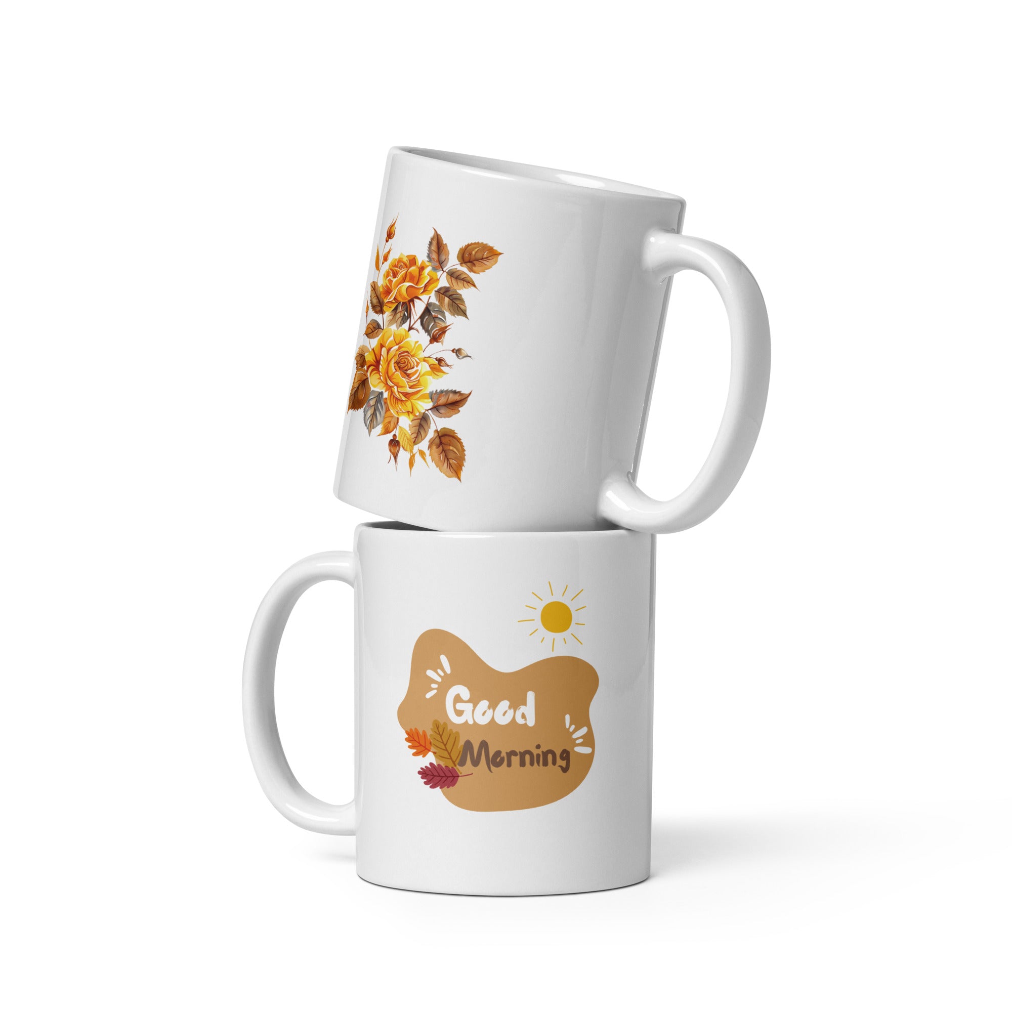 A set of two ceramic mugs, one with a floral design of golden roses and autumn leaves, and the other with a sun and leaves pattern, both with 'Good Morning' and 'Good Afternoon' text respectively.