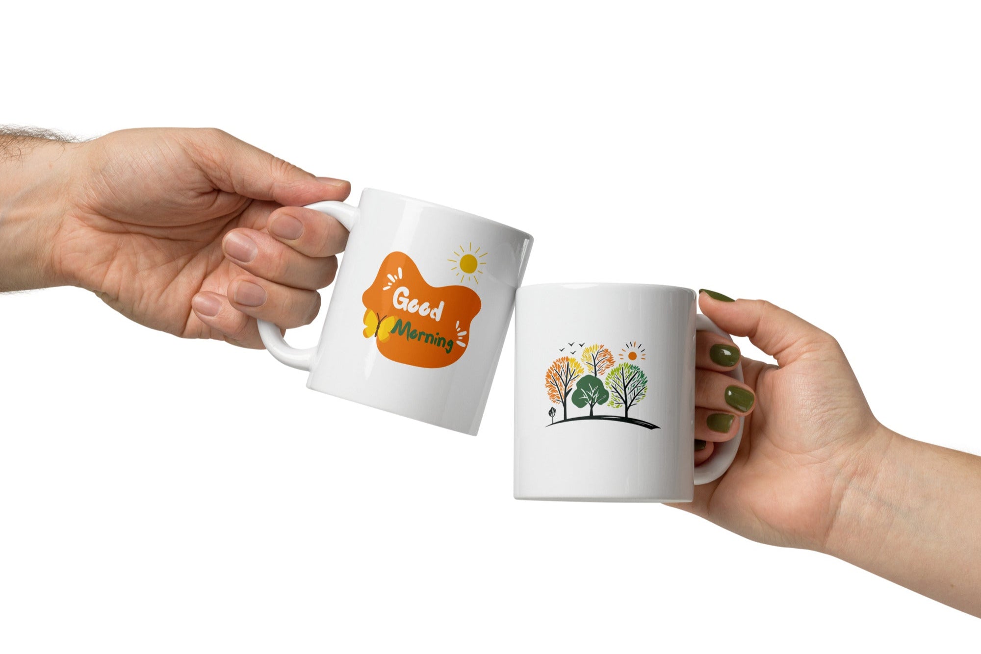 Two ceramic mugs with nature-inspired designs. One mug displays a colorful forest scene with trees and the sun, while the other mug has a 'Good Morning' message with a sun and coffee-related graphics.