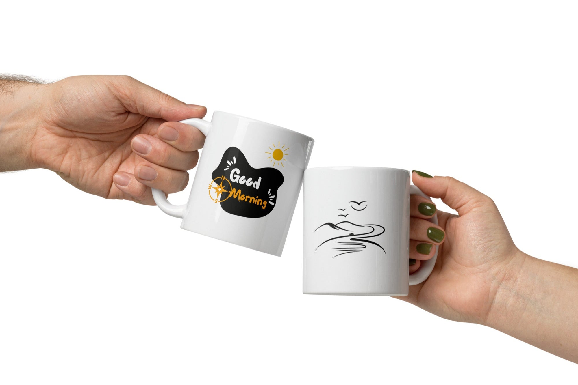 Two ceramic mugs side by side, one with a mountain design and the other with a sunrise and sunburst design, both featuring text 'Good Morning'.