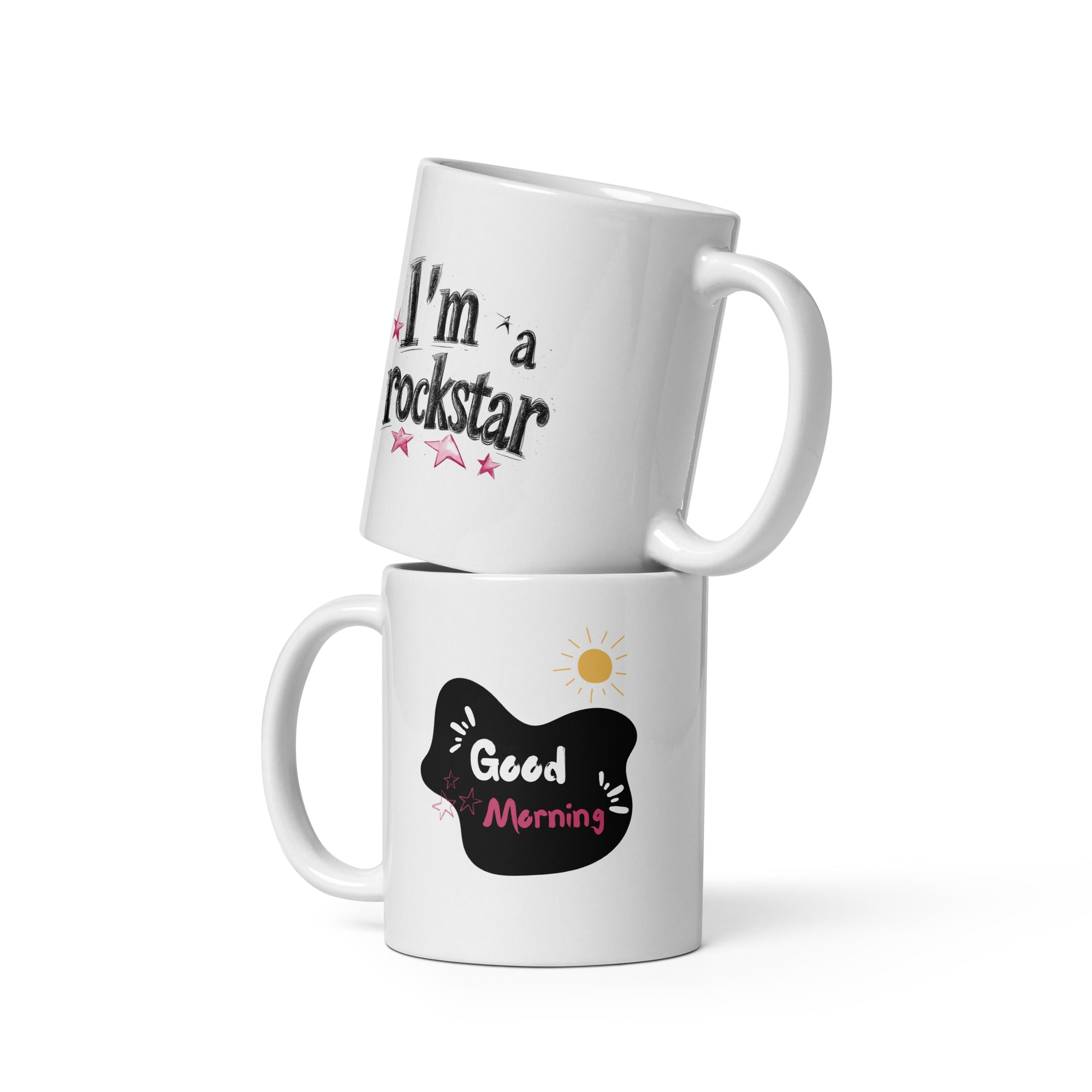 Two ceramic mugs side by side, one with the phrase 'I'm a Rockstar' and stars, the other with 'Good Morning' and a sun graphic, both in black, white, pink, and yellow.