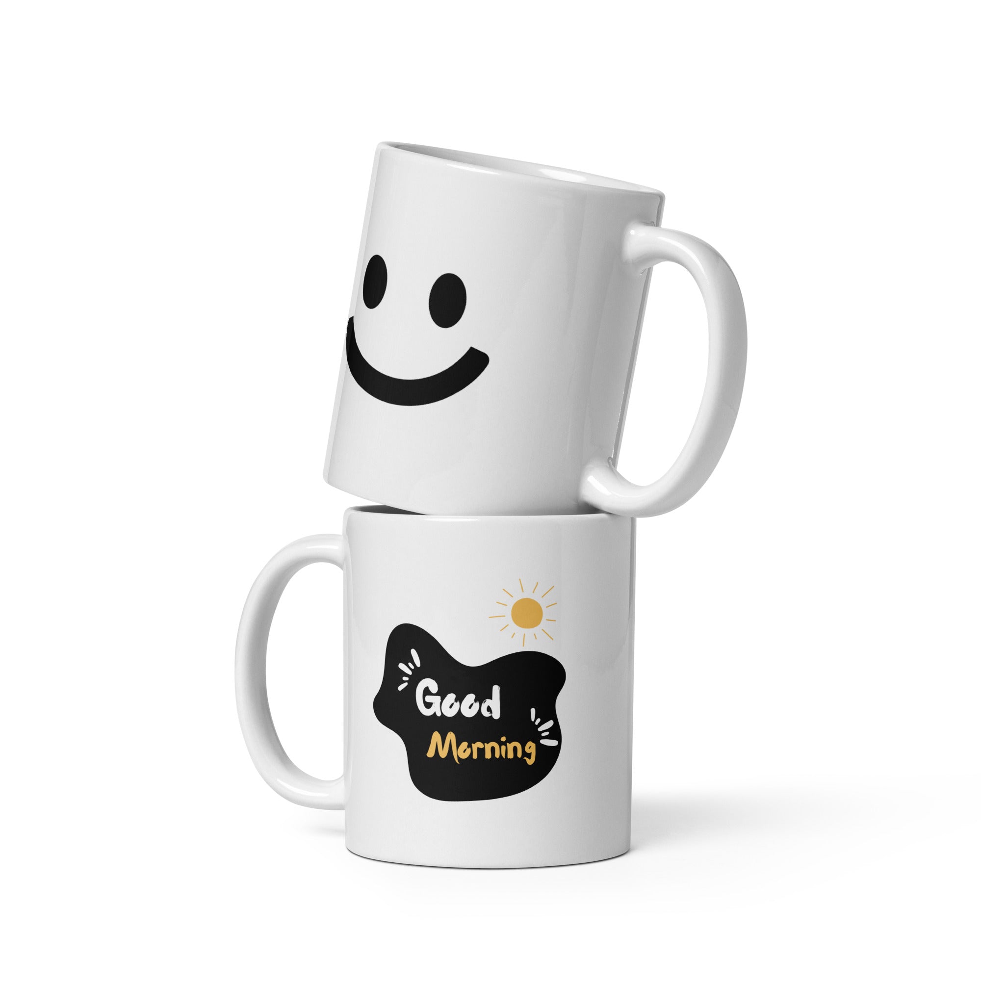 Two ceramic mugs, one with a minimalist smiley face design and the other with 'Good Morning' text and a sun graphic, both in black and yellow colors on a white background.