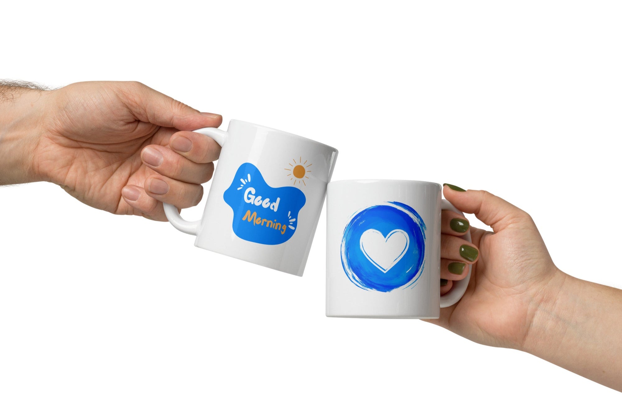Two ceramic coffee mugs, one with a blue heart design and the other with a 'Good Morning' message alongside a sun icon, both with white backgrounds.