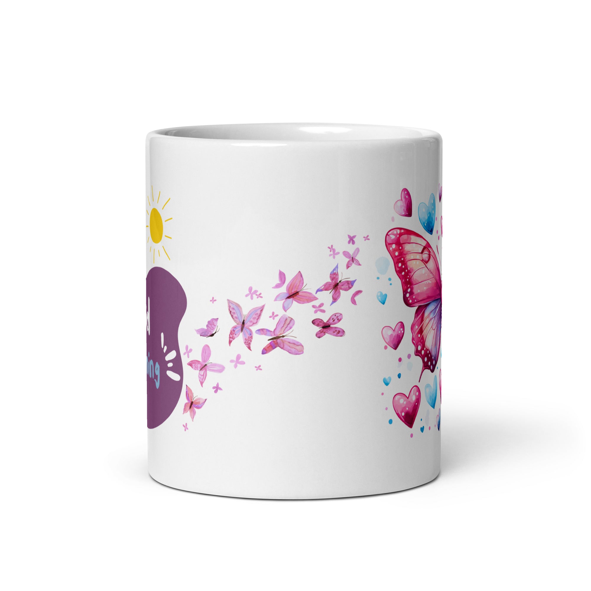 A ceramic coffee cup with a pink butterfly and hearts design, and a text message that reads 'Good Morning'.