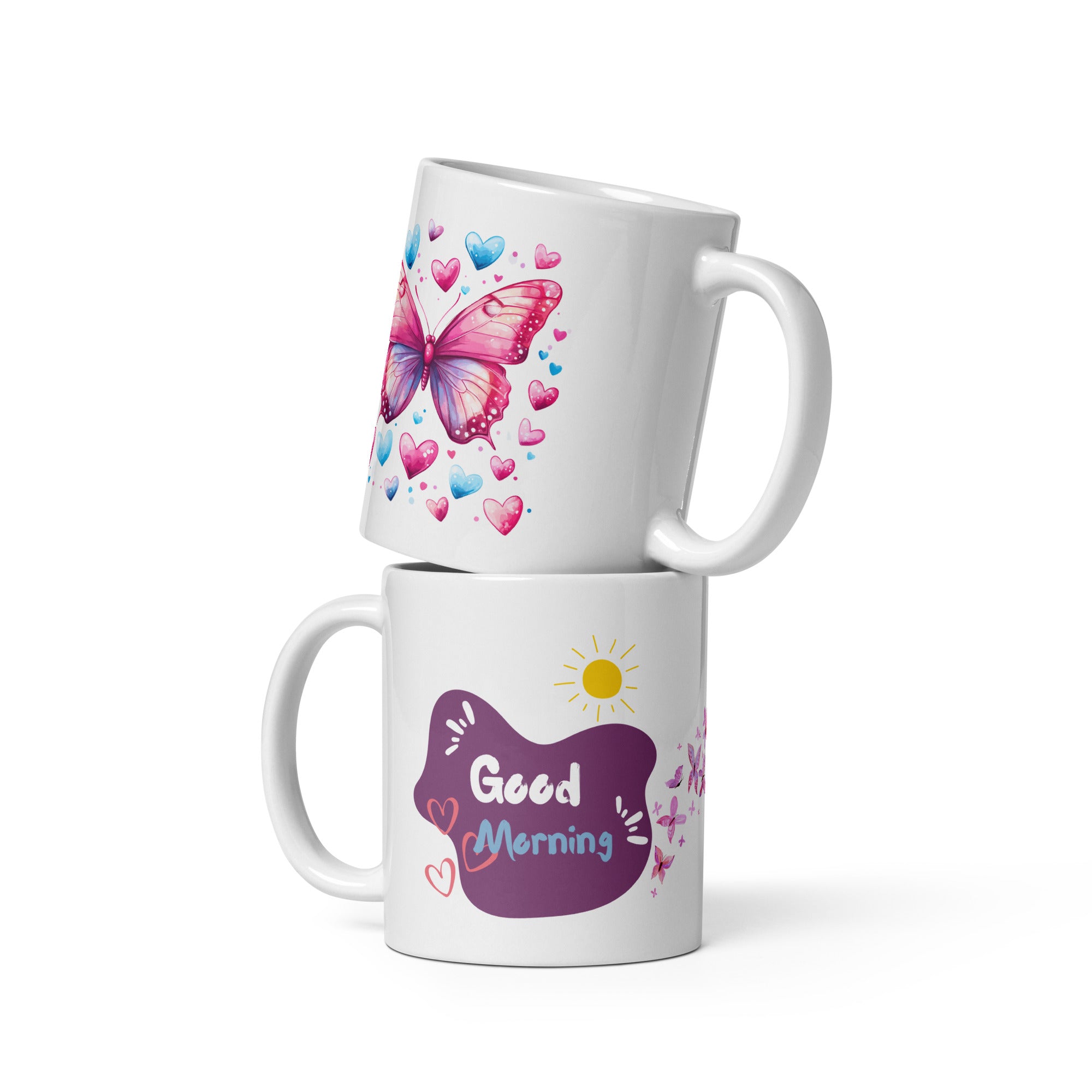 A ceramic coffee cup with a pink butterfly and hearts design, and a text message that reads 'Good Morning'.