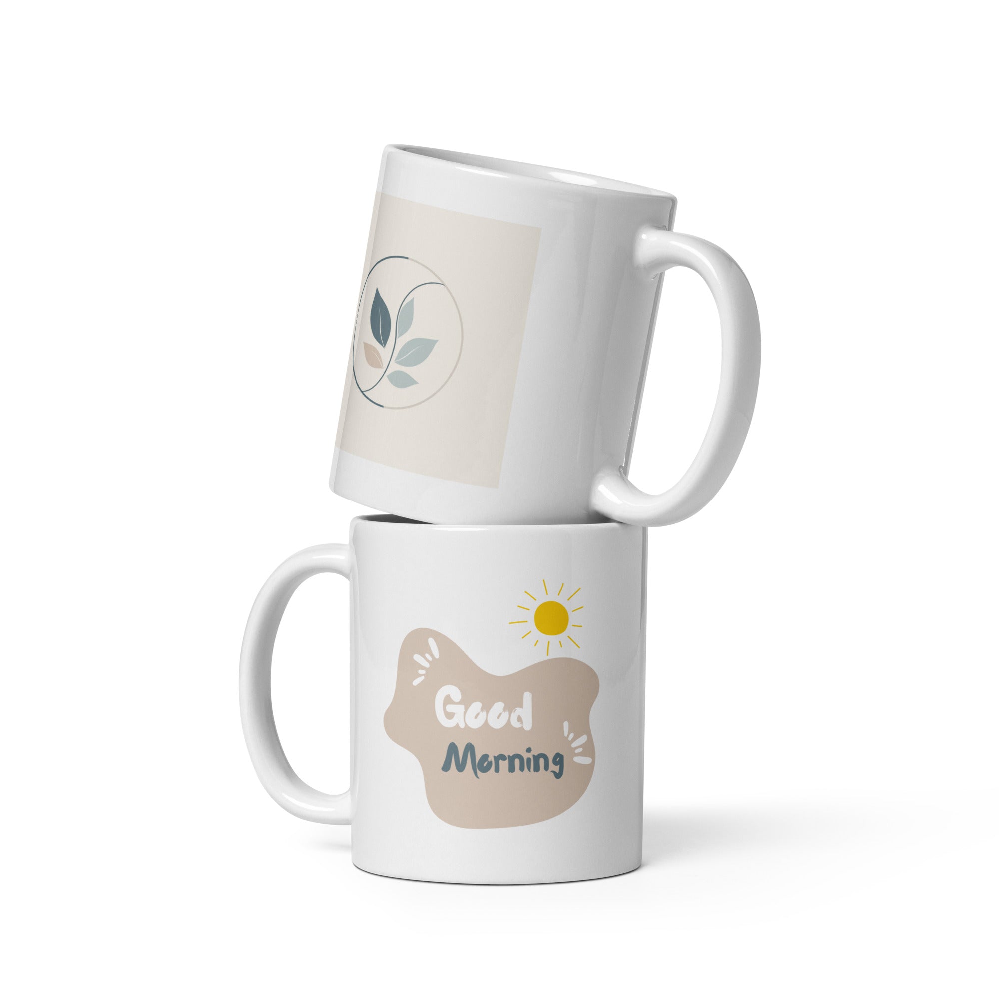 Two ceramic mugs, one with a 'Good Morning' message and a sun icon, and the other with a 'Good Mornin' spelling mistake, both with nature-inspired leaf designs.