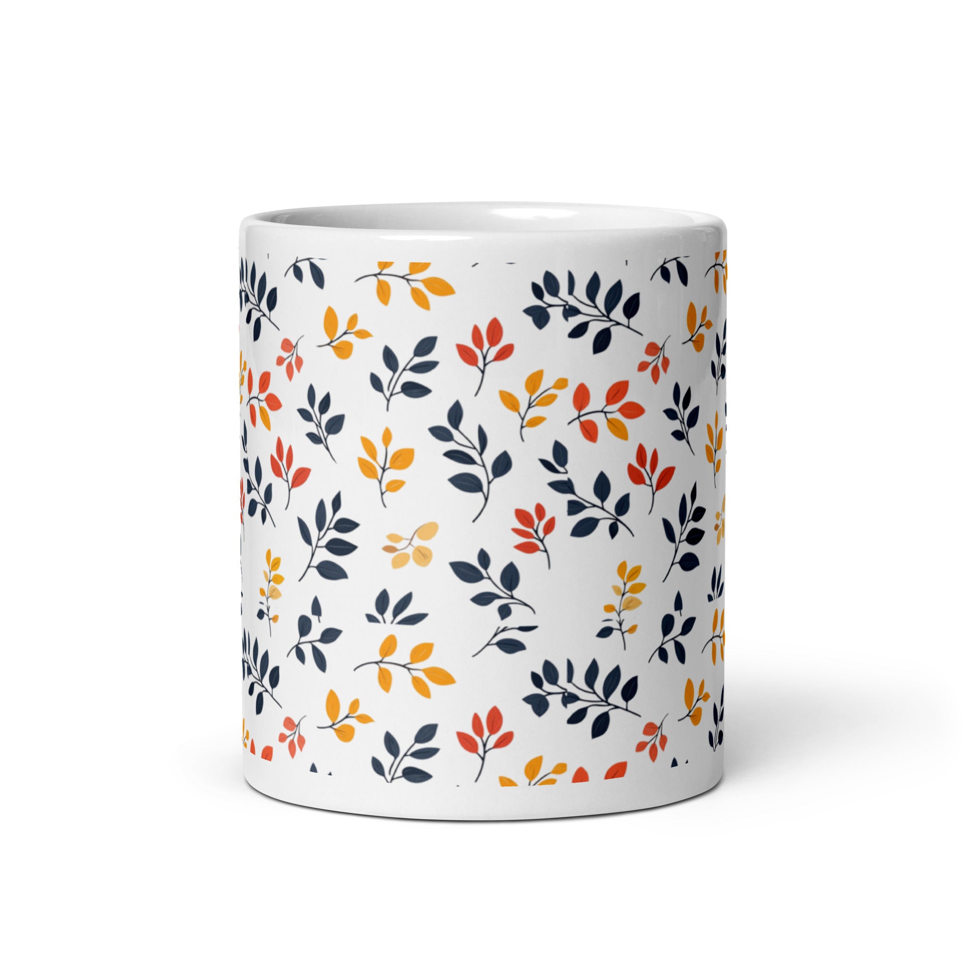 A set of two ceramic coffee mugs with a floral and autumn leaf design on a white background, one mug is filled with a liquid, possibly coffee or tea.